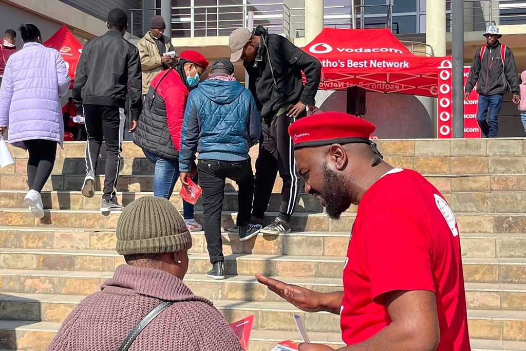 Vodacom staff on the ground interacting with customers.