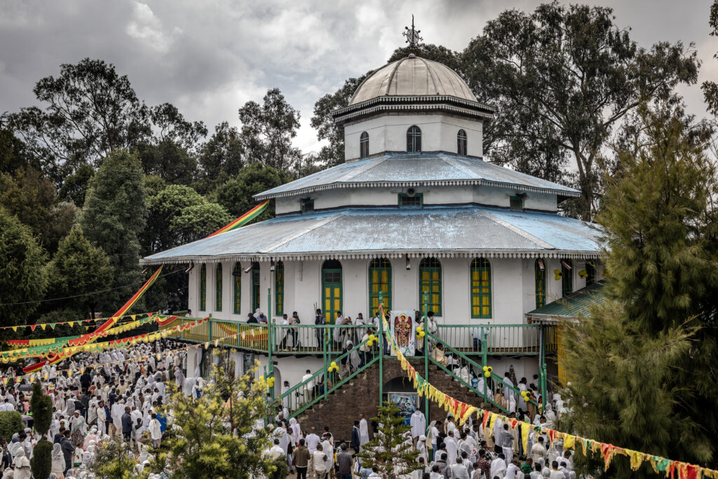 Ethiopian Orthodox faithful gather to sing religious songs and prayers during a New Year church celebration at Entoto St. Raguel Church in Addis Ababa, on September 11, 2025. Ethiopia marks the New Year, Enkutatash in Amharic, on September 11, celebrating the end of the rainy season and the start of the Ethiopian calendar year 2018, which runs about seven to eight years behind the Gregorian calendar. (Photo by Luis TATO / AFP)