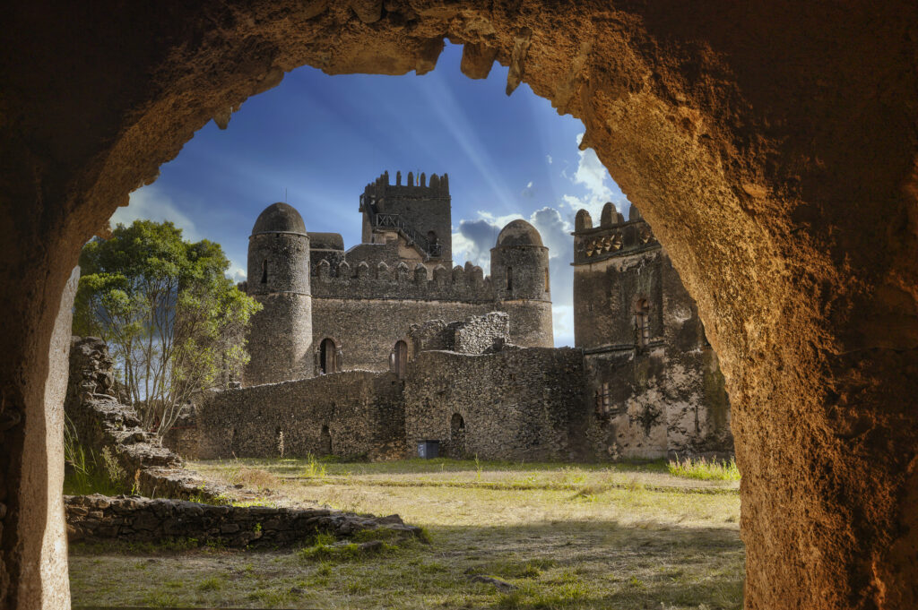 View of the ruins of Fasilides' Castle in Gondar, Ethiopia framed by the arch of a door