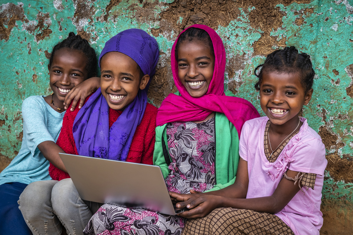 Young African girls using laptop in the village in Central Ethiopia, Africa.